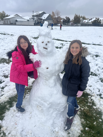 Girls building snowman