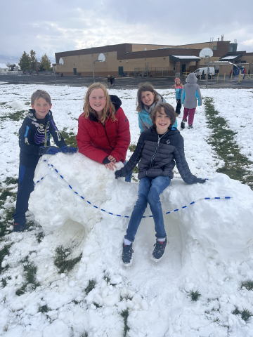 Children building snow fort
