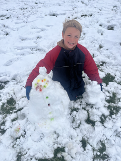Boy building snowman